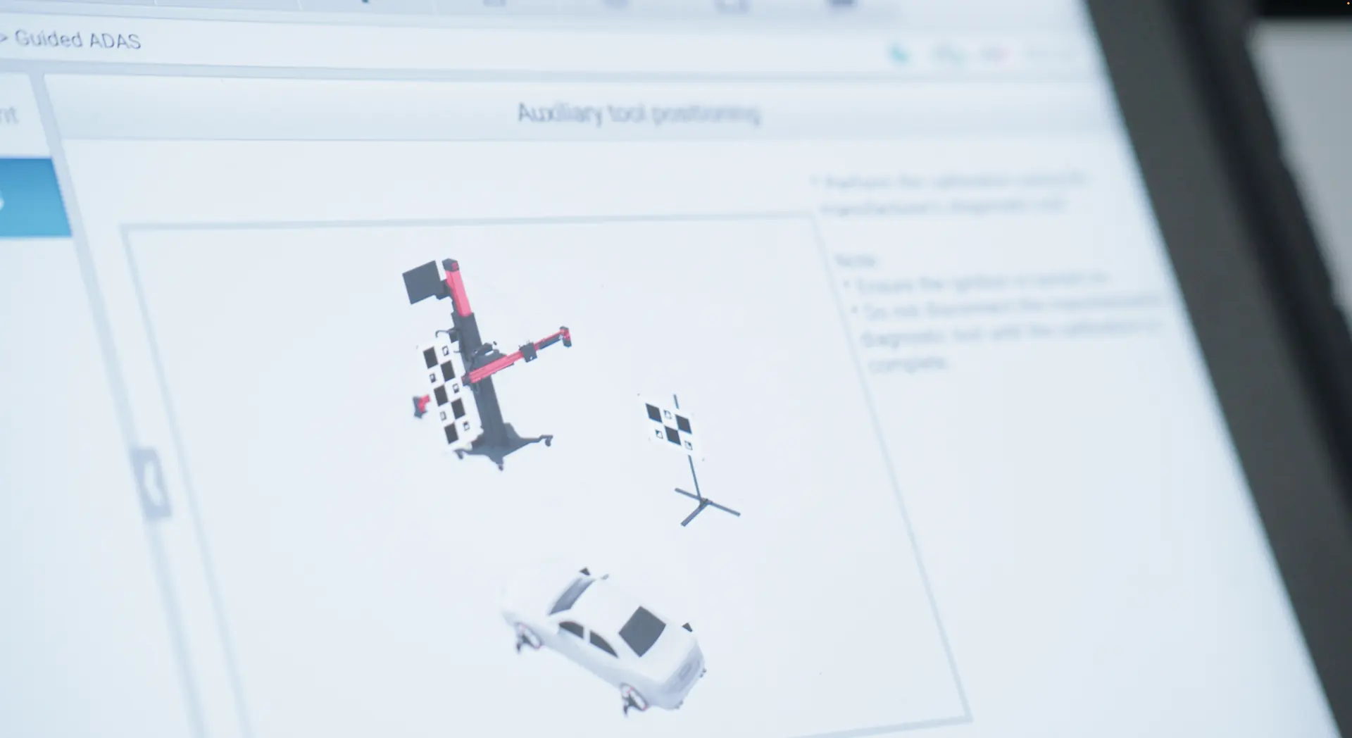 A screen showing the guided ADAS software at the auxiliary tool positioning step.