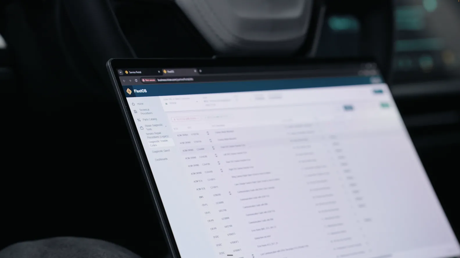 A laptop screen showing a vehicle module list during a restraint-system scan.